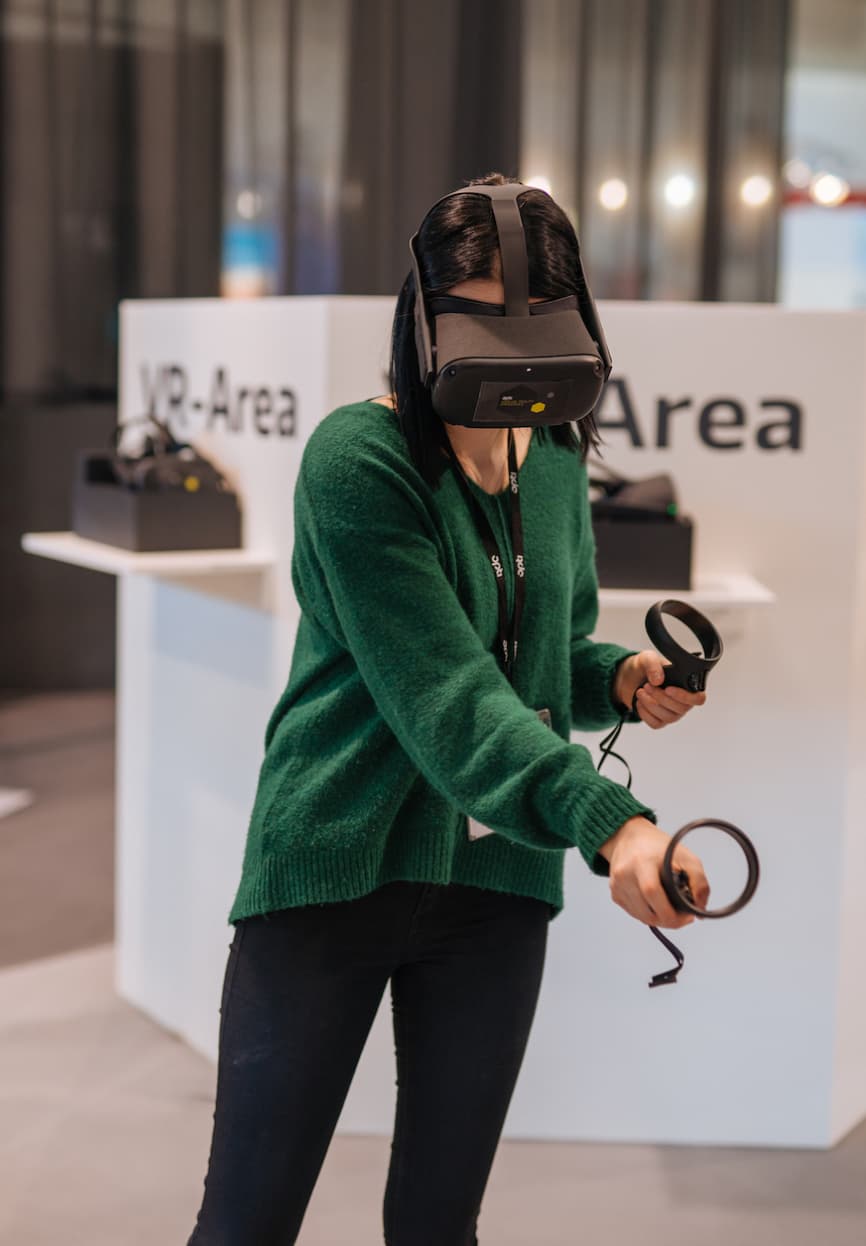 &why: opti VR - Person wearing a VR headset and the controllers